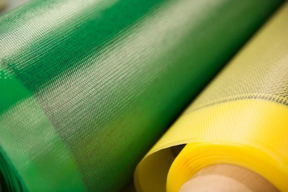 Rolls of green and yellow mesh fabric